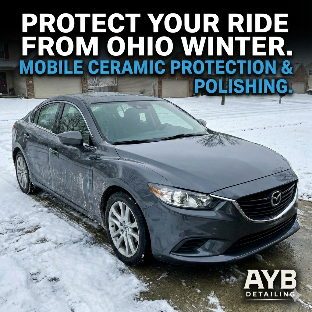 Mobile detailing professional applying ceramic coating to car paint during winter in Ohio