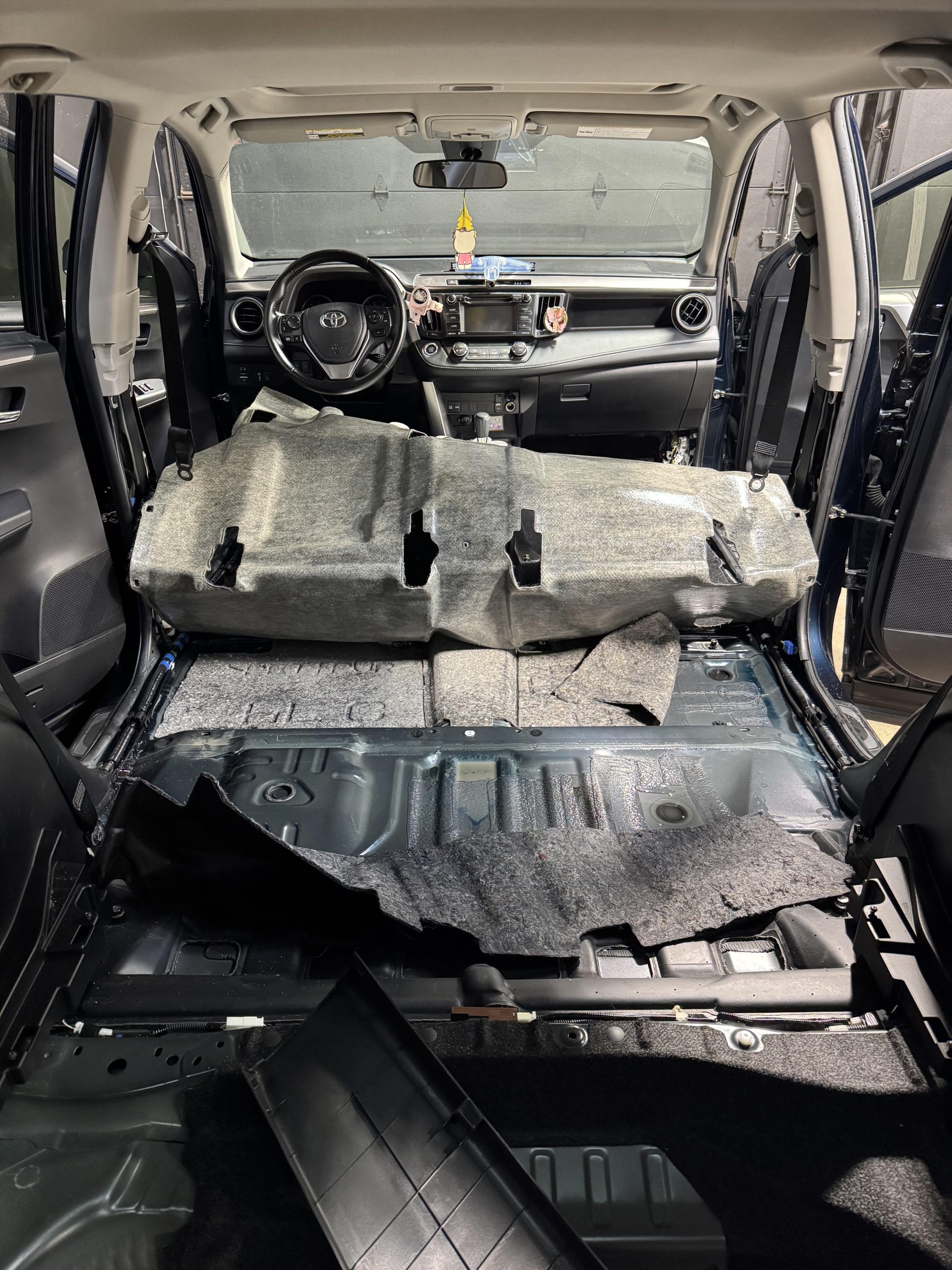 Full interior disassembly of Toyota - seats and carpet removed for deep cleaning, odor elimination, and floor restoration